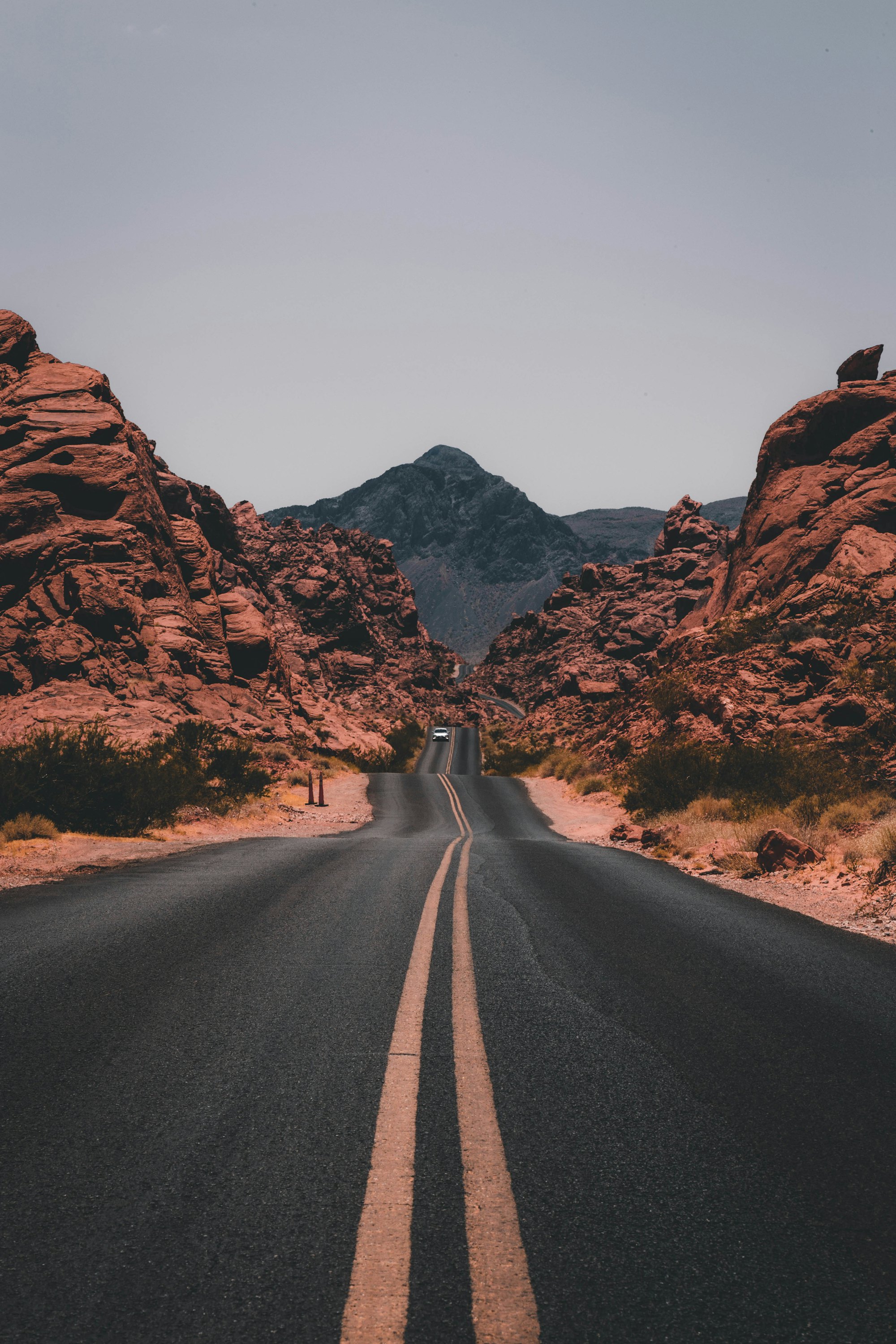 Open road winding through red desert canyons
